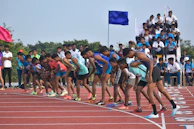 Athletes preparing at the starting line, focused and ready to race.