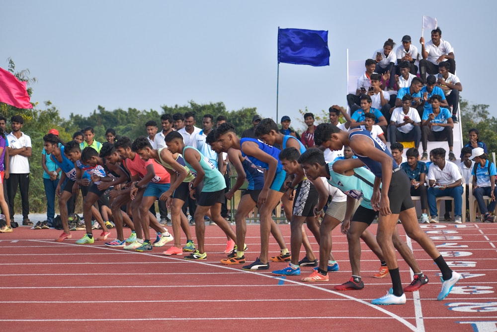 a group of people standing on top of a race track