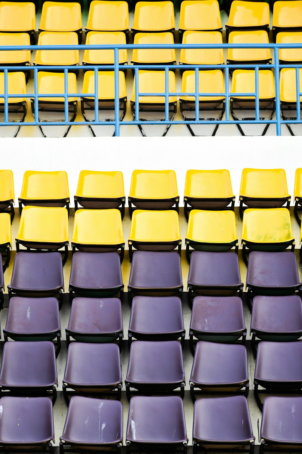 a row of yellow and purple chairs sitting next to each other