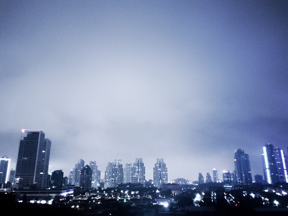 a view of a city at night from the top of a hill