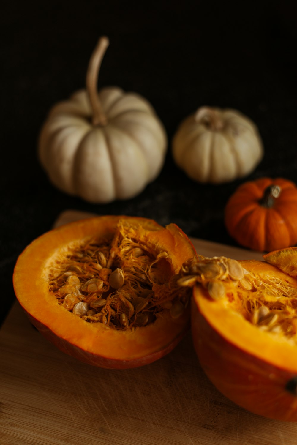 pumpkins cut in half on a cutting board