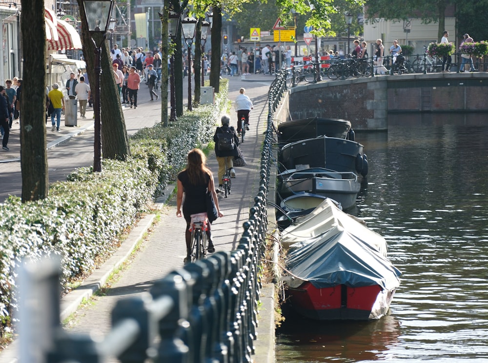 a woman riding a bike next to a body of water