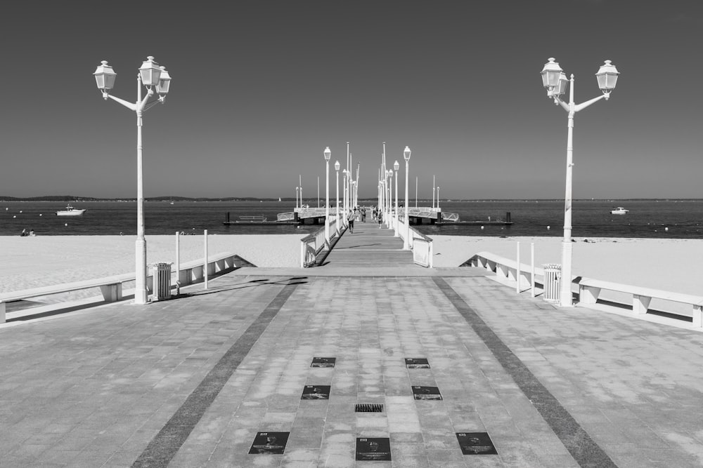 a black and white photo of a pier