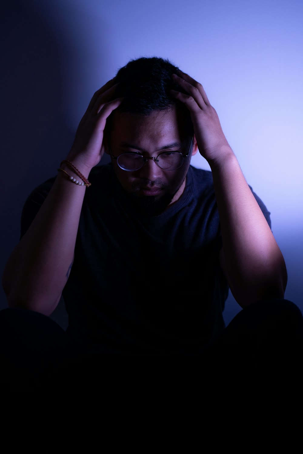 a man sitting in front of a laptop computer