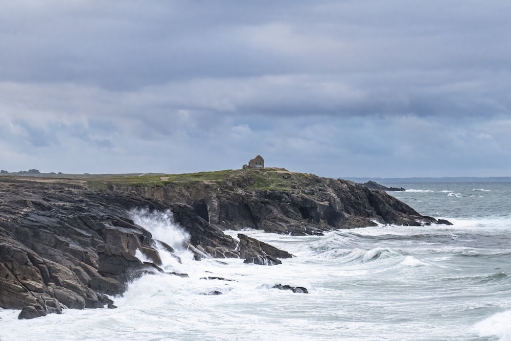 a large body of water next to a rocky shore