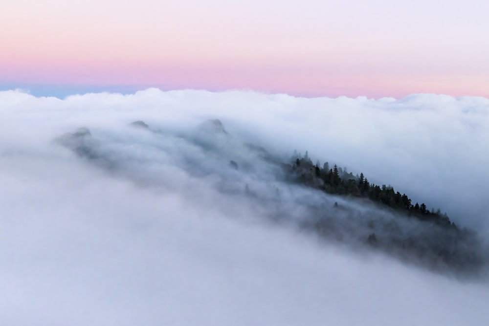 a view of a mountain covered in clouds