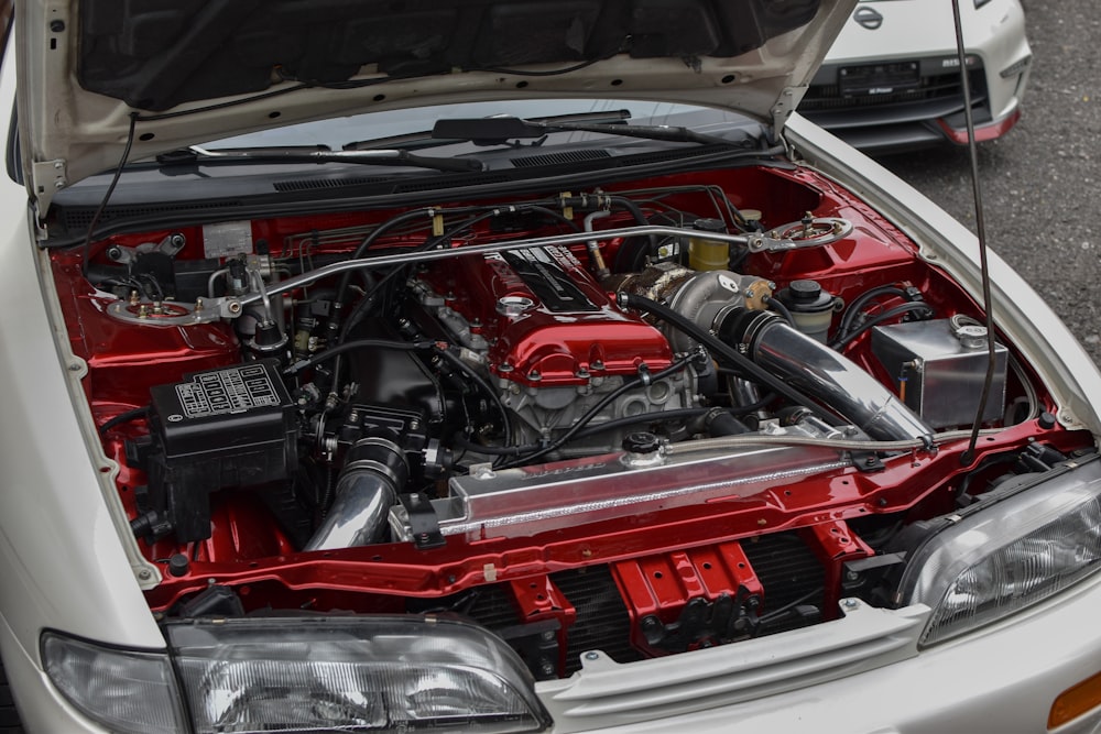 the engine of a white car with its hood open