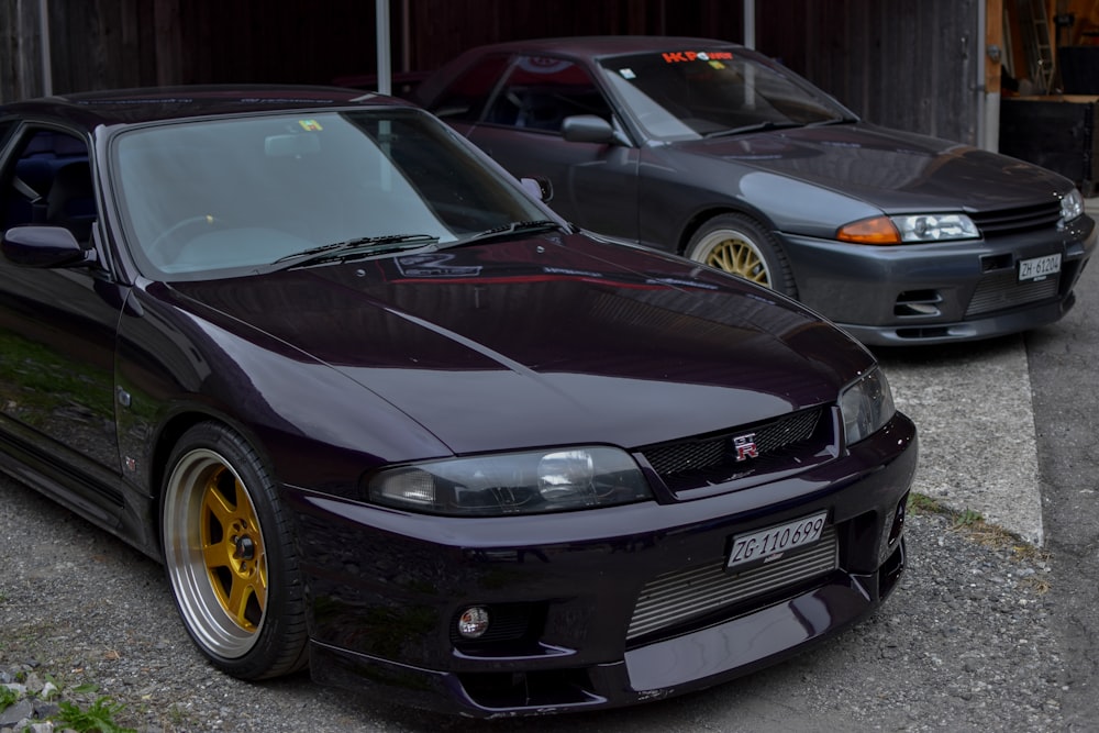 two cars parked next to each other in front of a garage