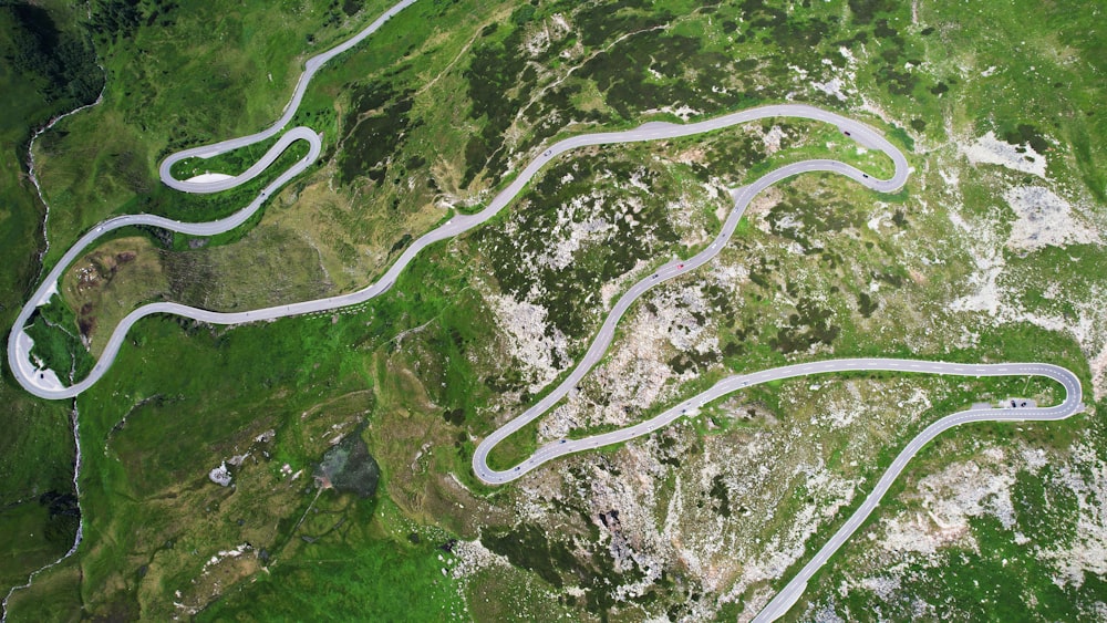 an aerial view of a winding road in the mountains