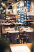 Cozy Scandinavian-style restaurant interior with warm lighting and rustic wooden tables.