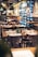 A cozy restaurant interior with tables set for dining, featuring warm lighting and inviting decor.
