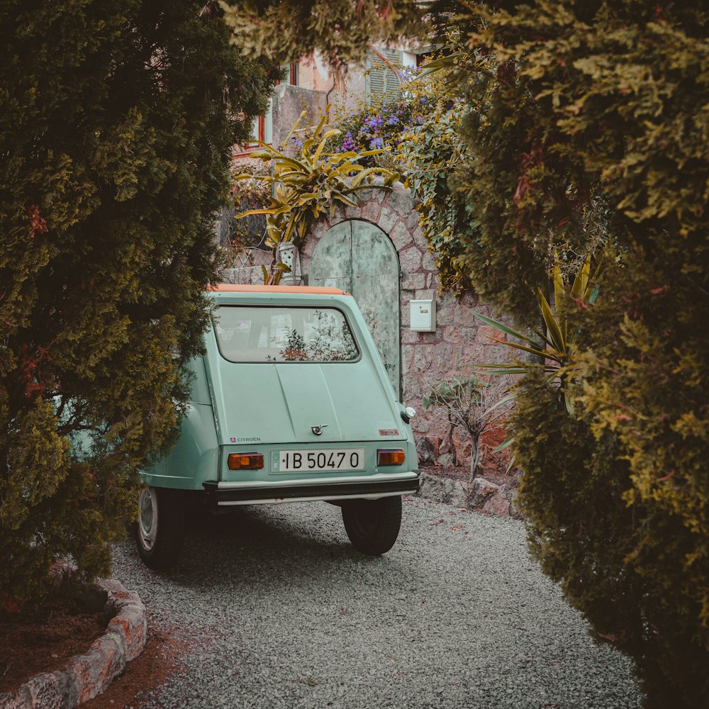 a small car parked in front of a building