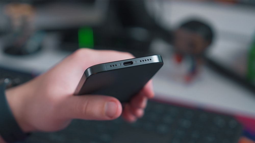 a close up of a person holding a cell phone