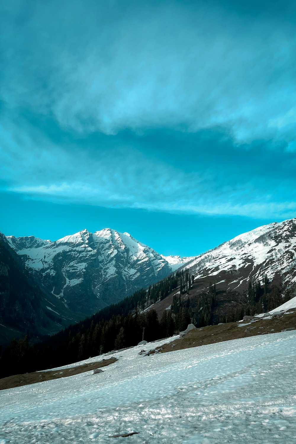 a man riding skis on top of a snow covered slope