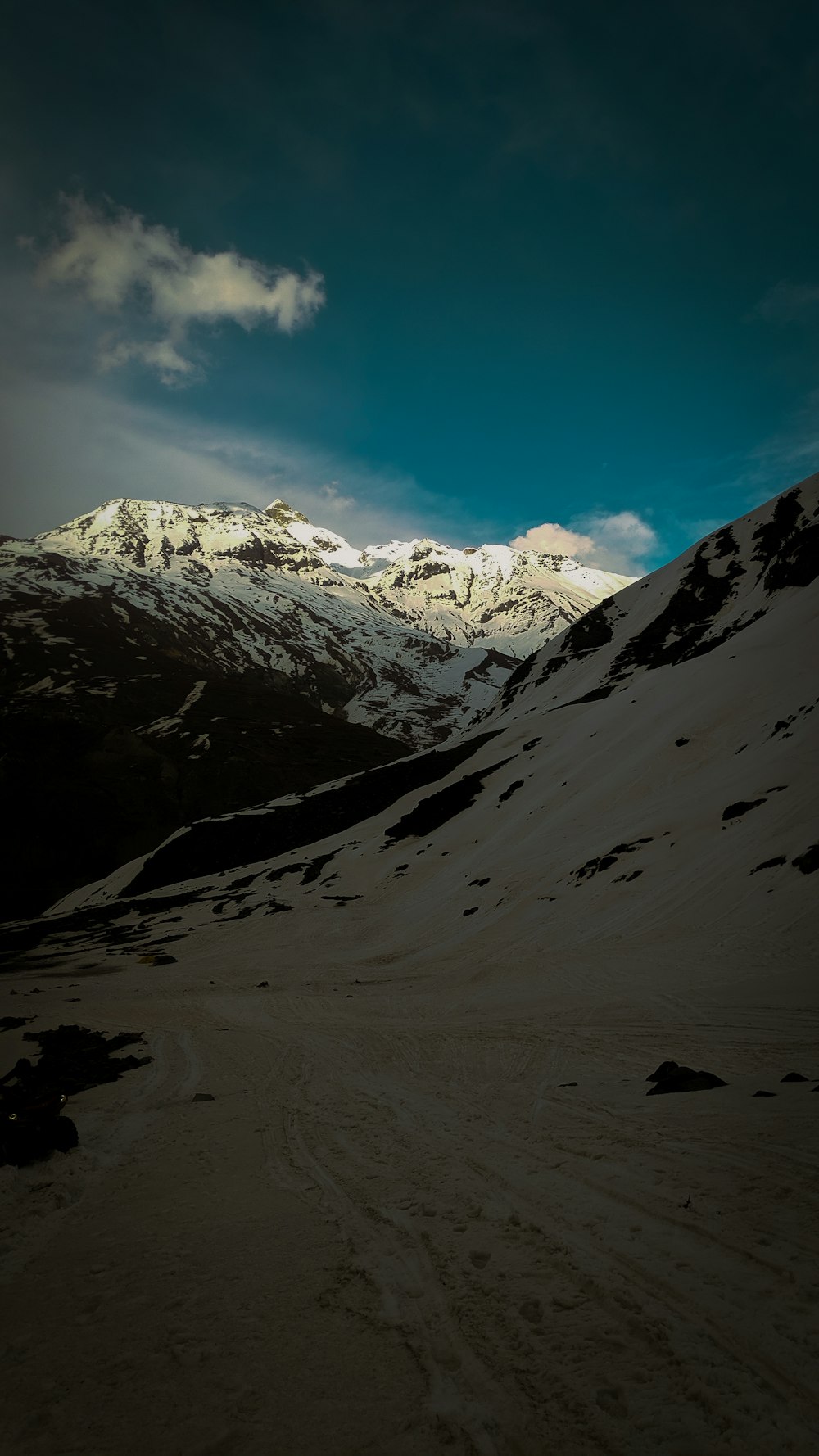 a snow covered mountain under a cloudy sky