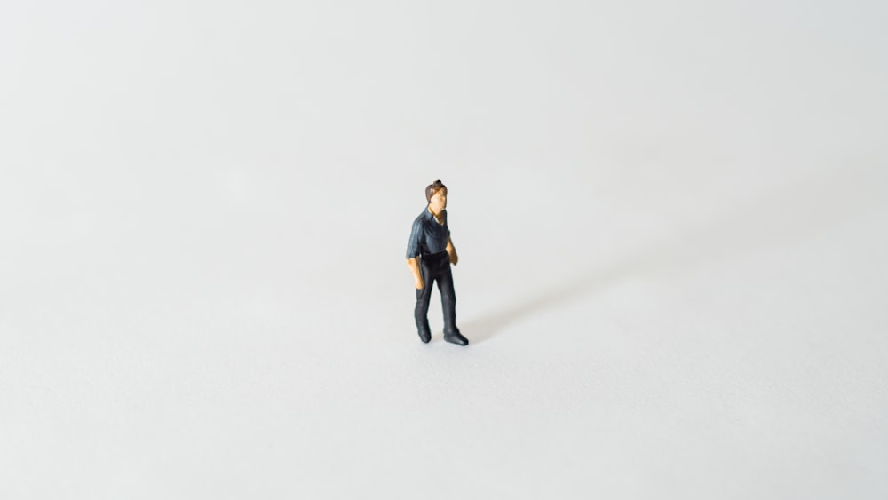 a small figurine of a man standing in the snow