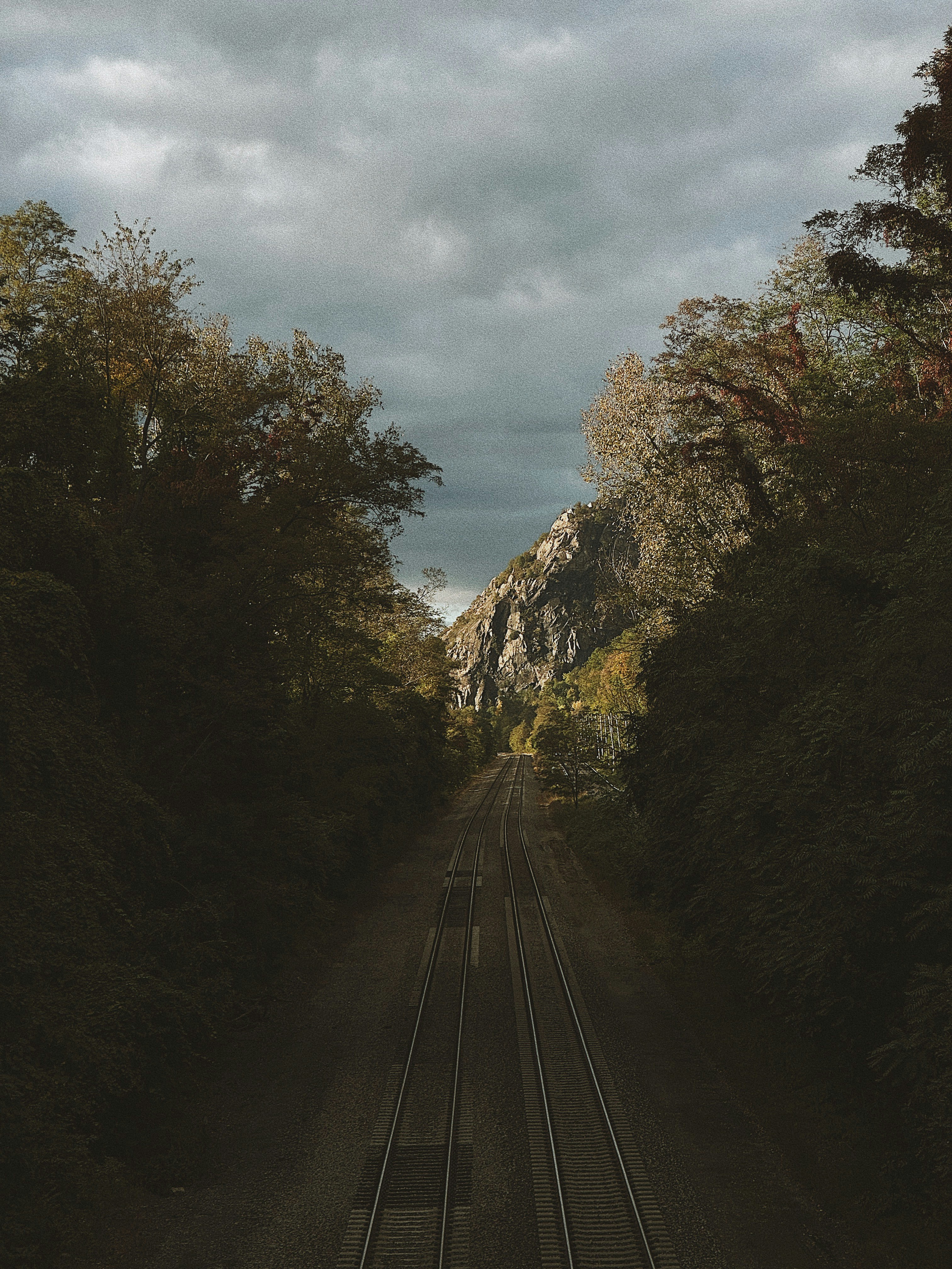 a train track with a mountain in the background