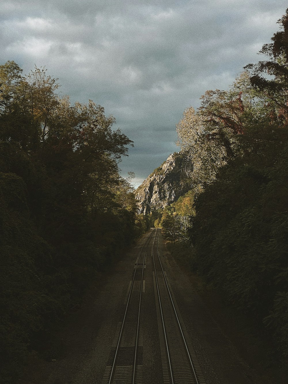 a train track with a mountain in the background