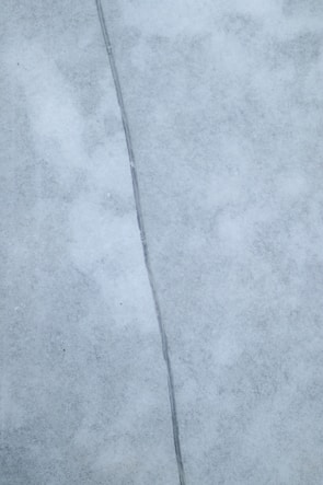 Before and after photos showing a repaired surface crack with smooth finishing.