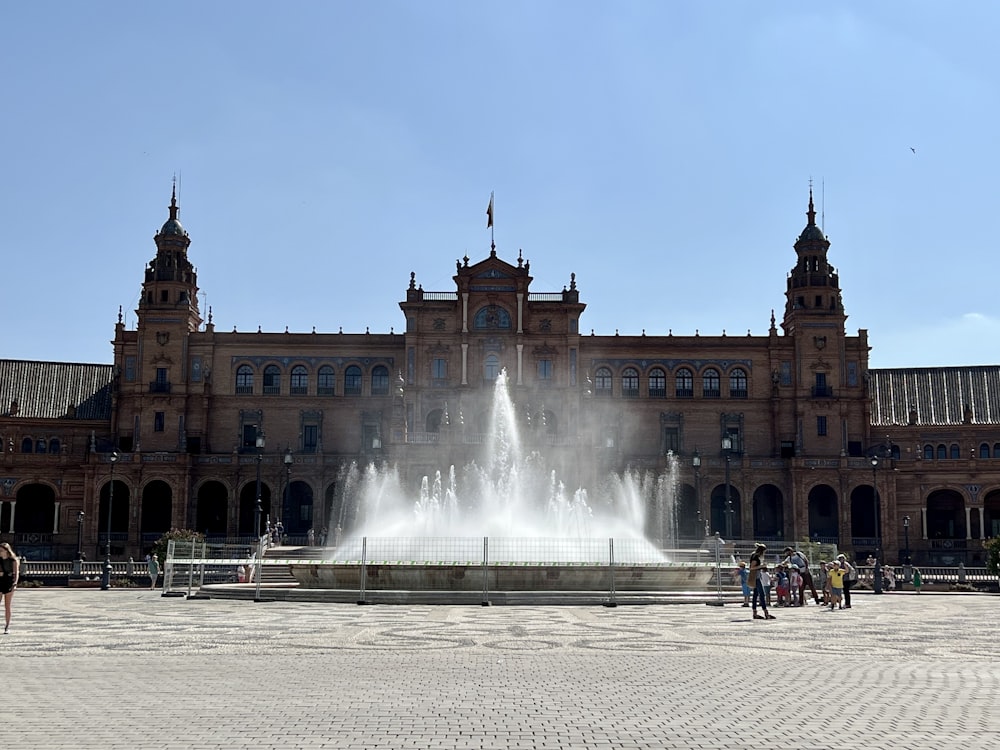 a large building with a fountain in front of it