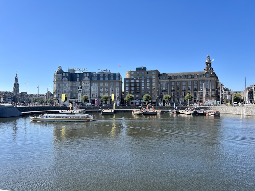 a boat is in the water in front of a large building