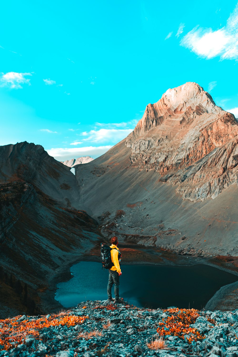 a person with a backpack standing on top of a mountain