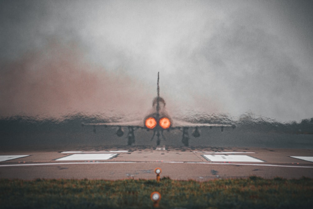 a fighter jet sitting on top of an airport runway