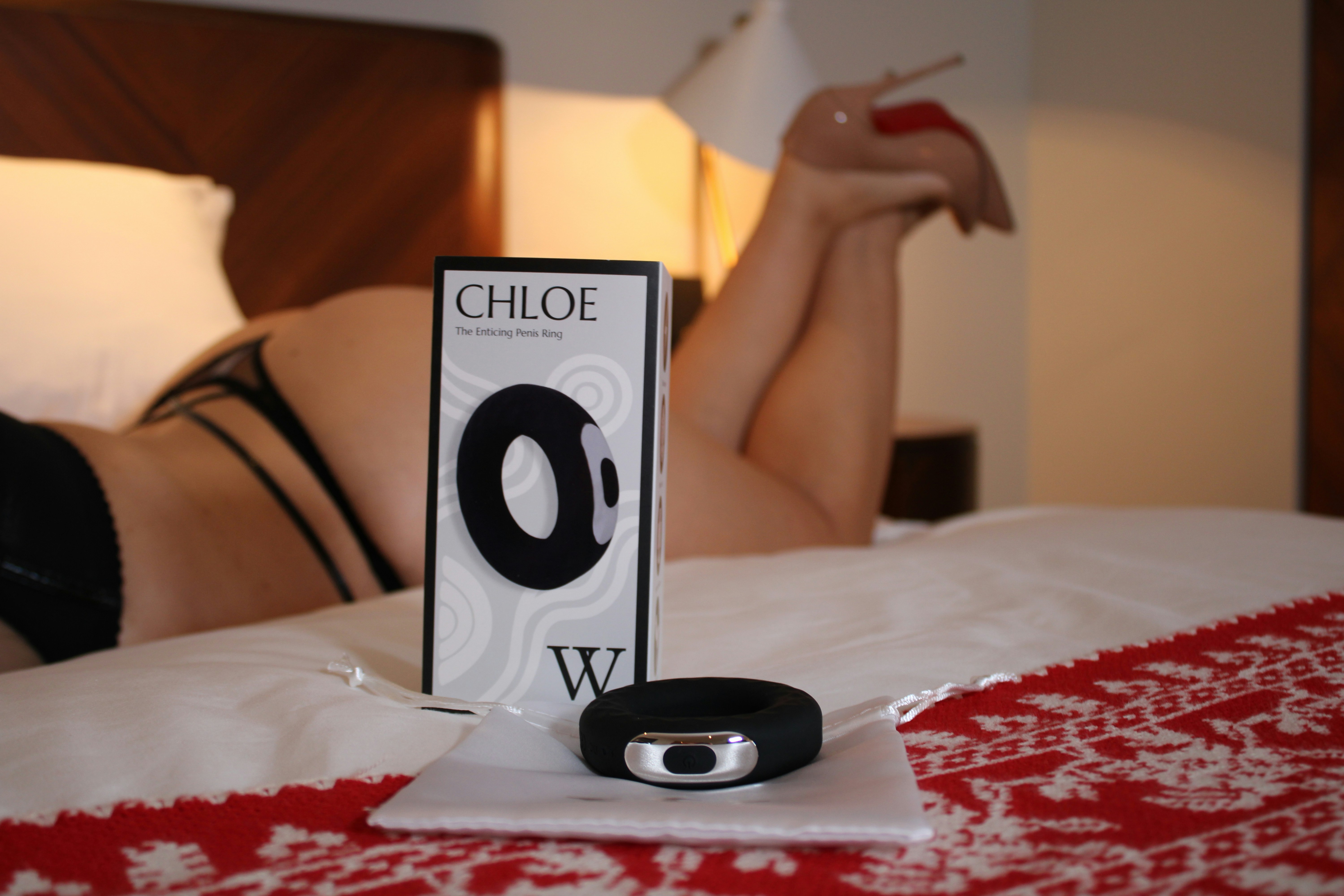 A male sex toy, a penis ring, is lying next to the model in a luxury hotel.