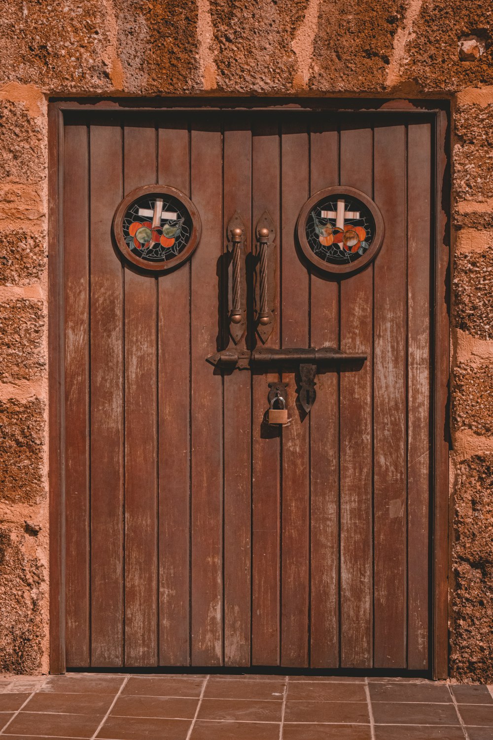 a wooden door with two crosses on it
