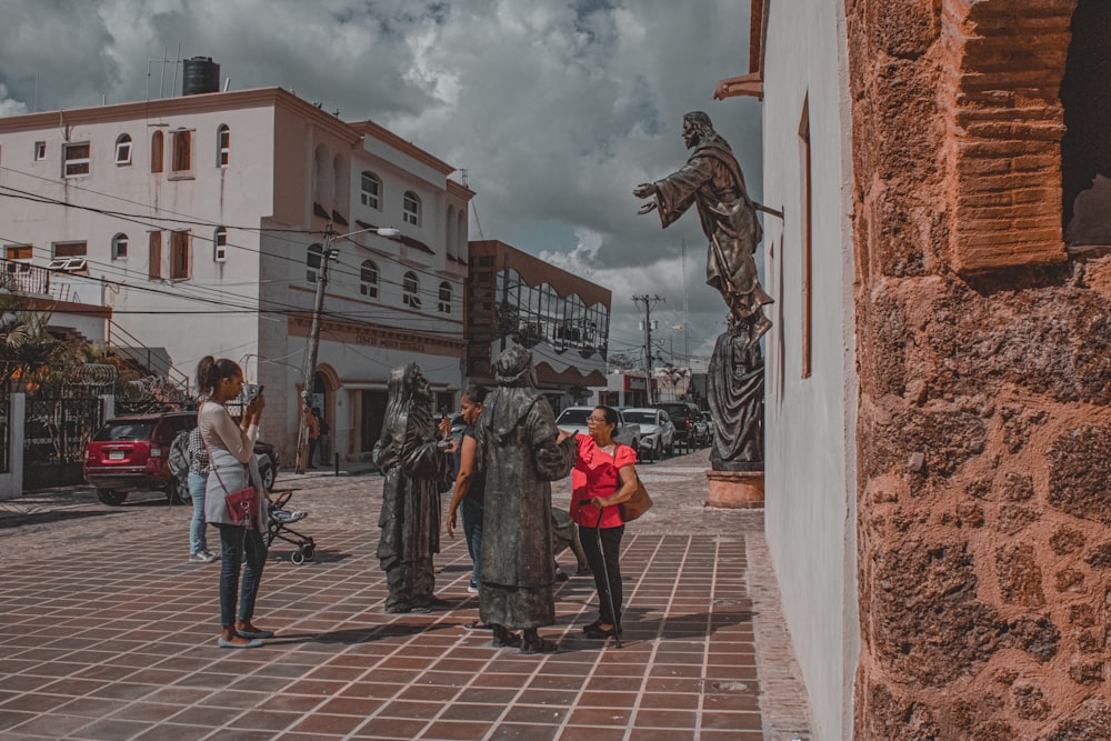 a group of people standing around a statue