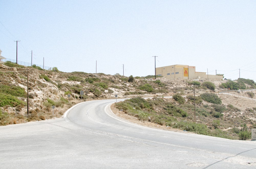 an empty road with a stop sign on the side of it