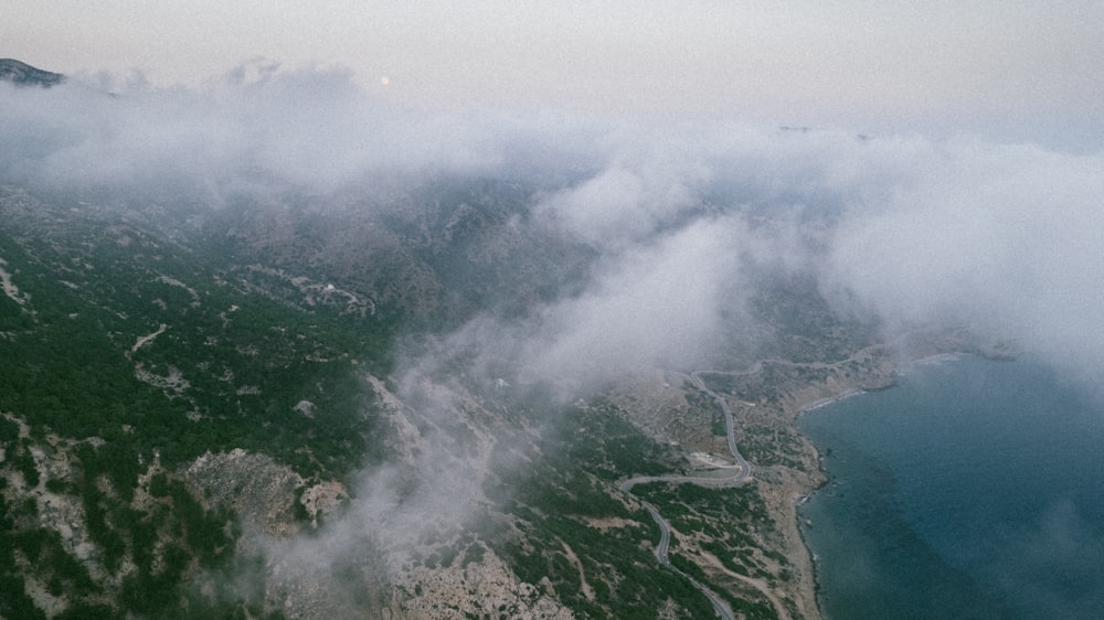 an aerial view of a mountain and a body of water