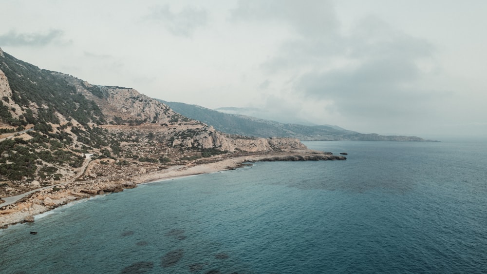 an aerial view of a rocky coastline and a body of water