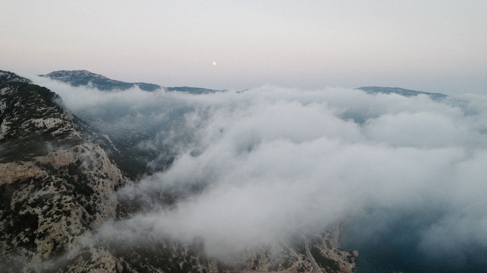 a view of a mountain covered in clouds