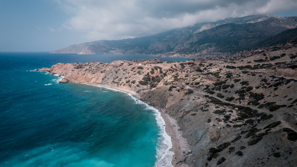 an aerial view of a beach and mountains