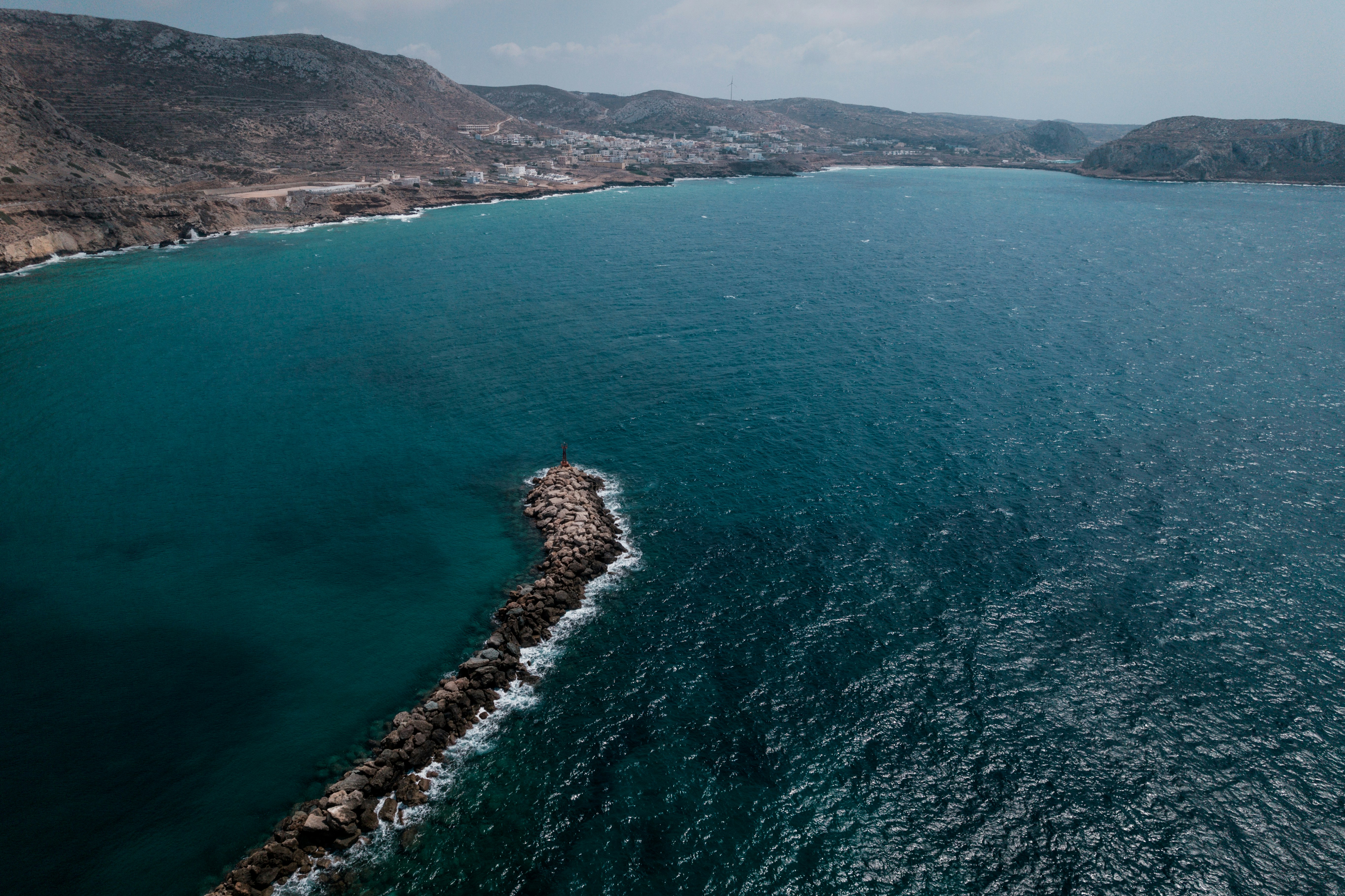 a large body of water next to a mountain range