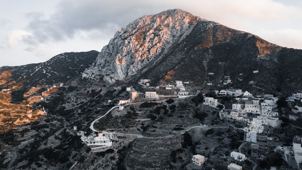 an aerial view of a mountain with a village below