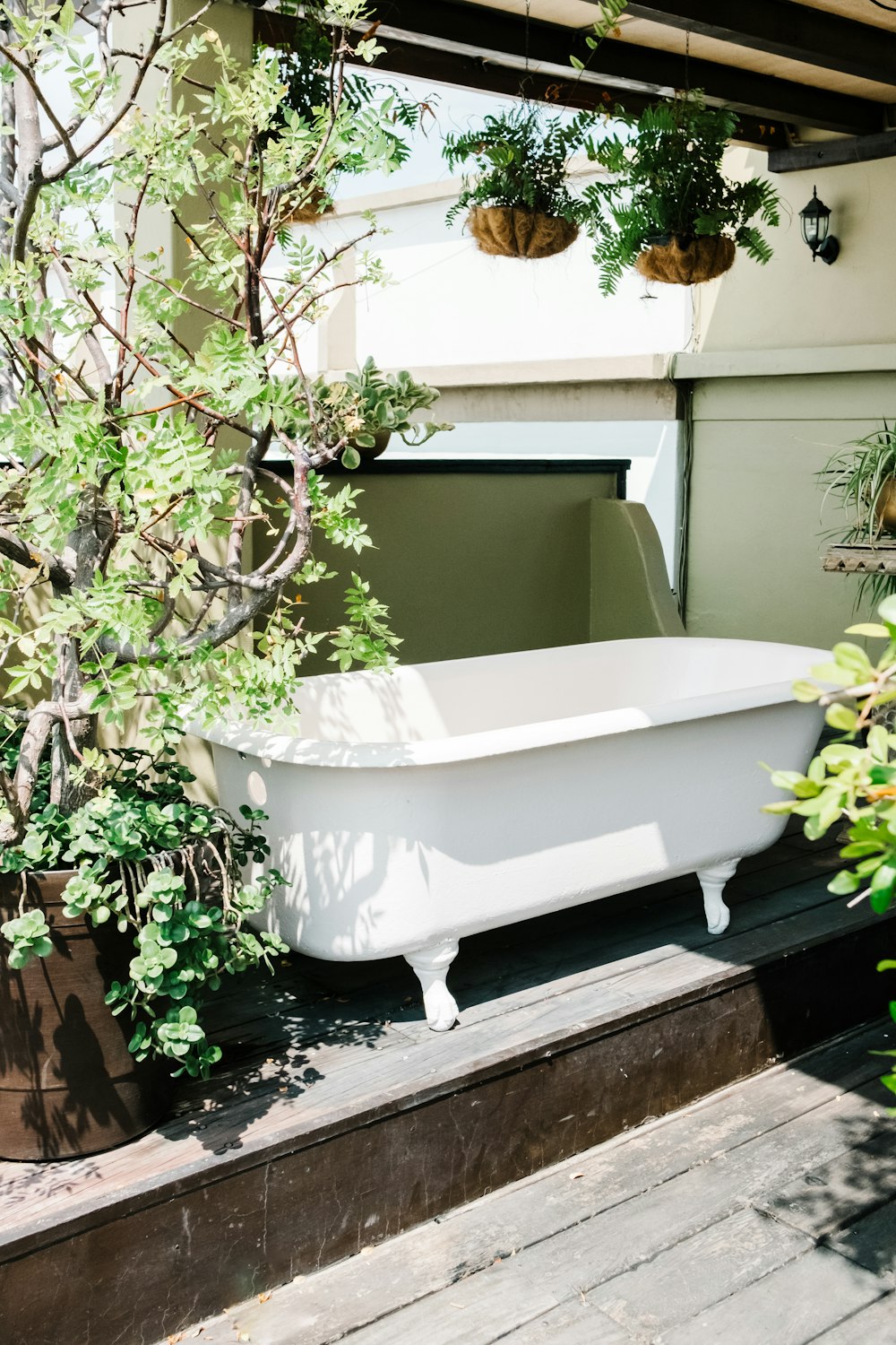 a white bath tub sitting on top of a wooden floor