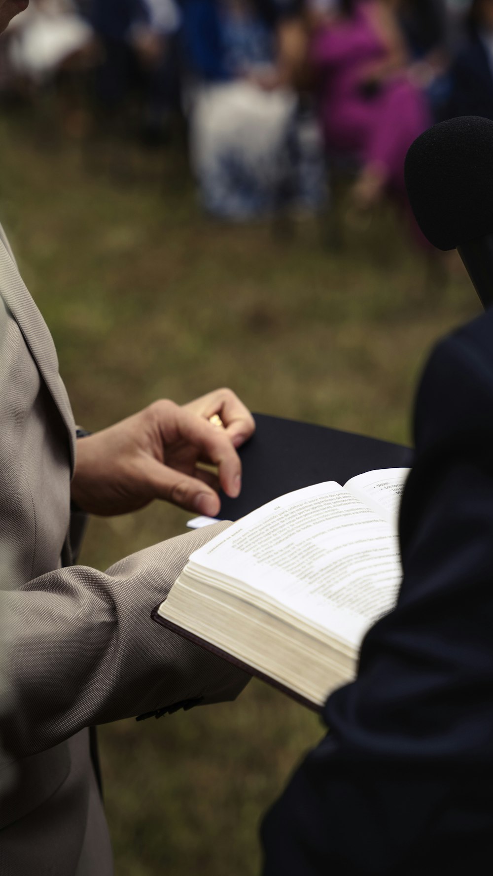 a person in a suit holding a book