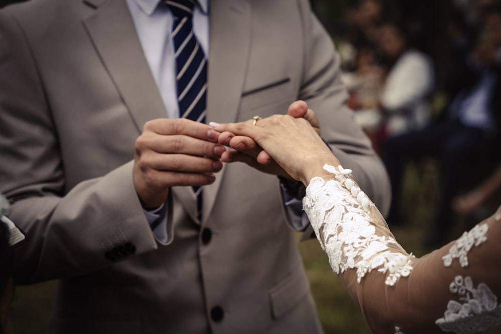 a bride and groom holding hands during a wedding ceremony