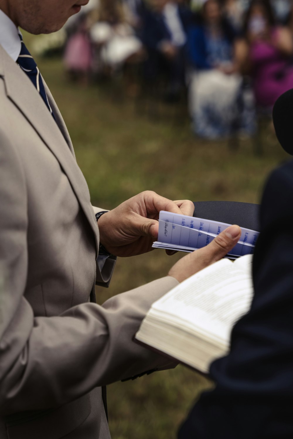 a man in a suit is holding a piece of paper