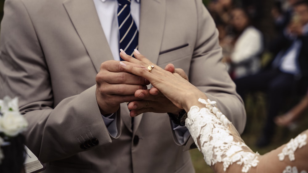 a bride and groom holding hands during a wedding ceremony