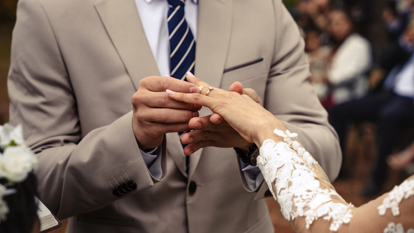 Wedding ceremony traditions — A bride and groom light a unity candle during their wedding ceremony.