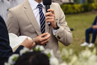 a man in a suit holding a microphone