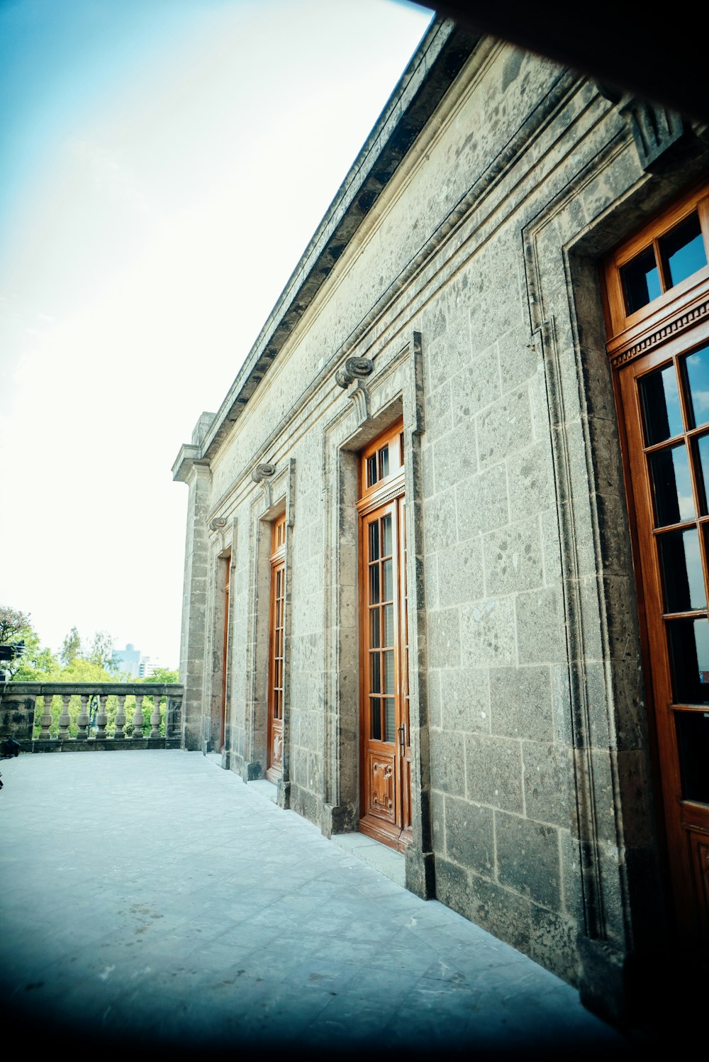 a stone building with two doors and a balcony