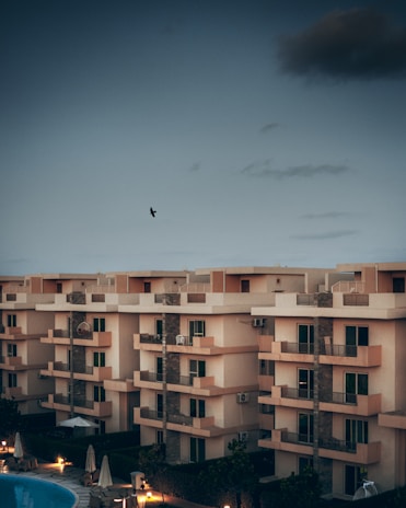Evening photo of an apartment balcony with pigeon nets installed, softly lit by ambient light.