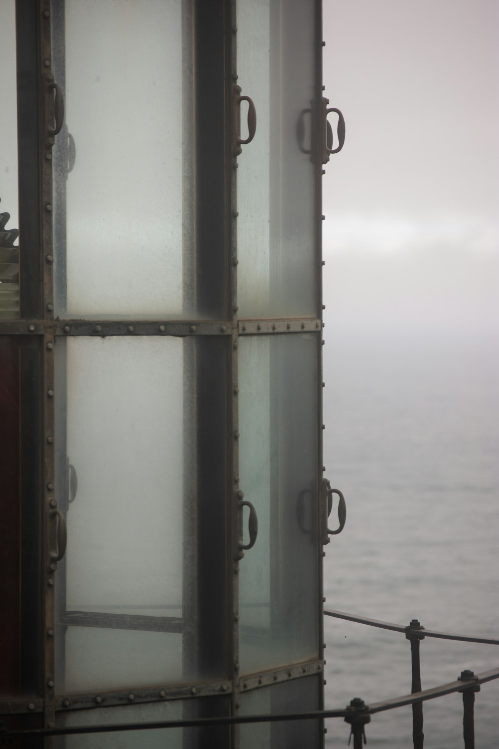 a close up of a window with a view of a body of water