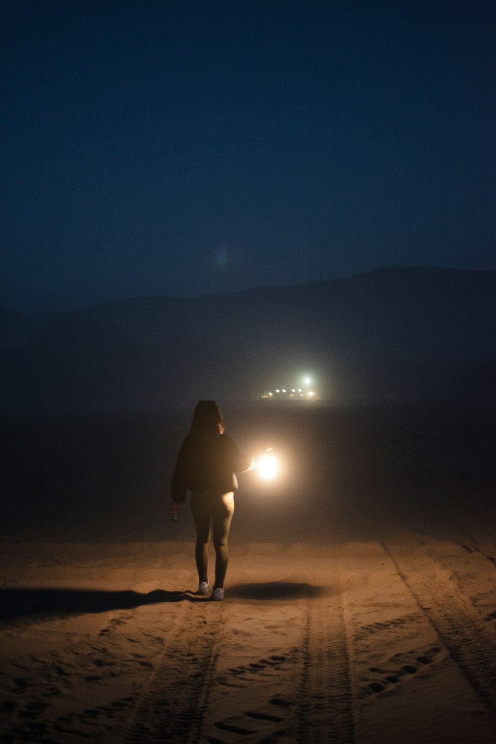 a person walking in the dark with a flashlight