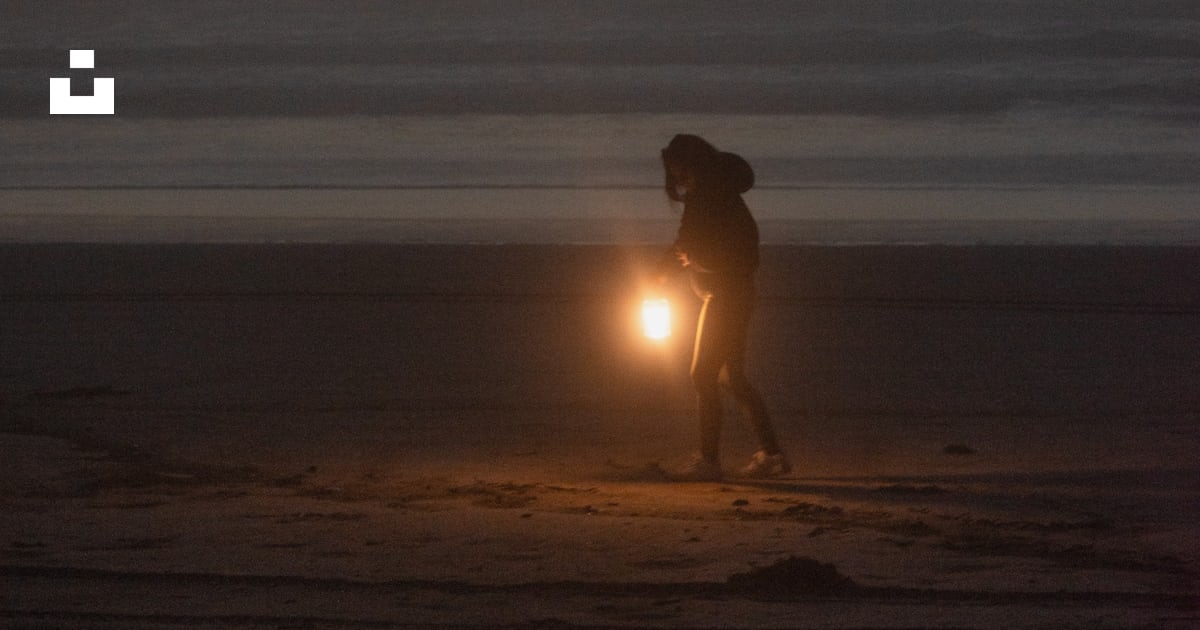 A person on a beach with a flashlight photo – Free Sand lake recreation ...