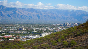 Scenic landscape of Valledupar with mountains and traditional vallenato music instruments in the foreground